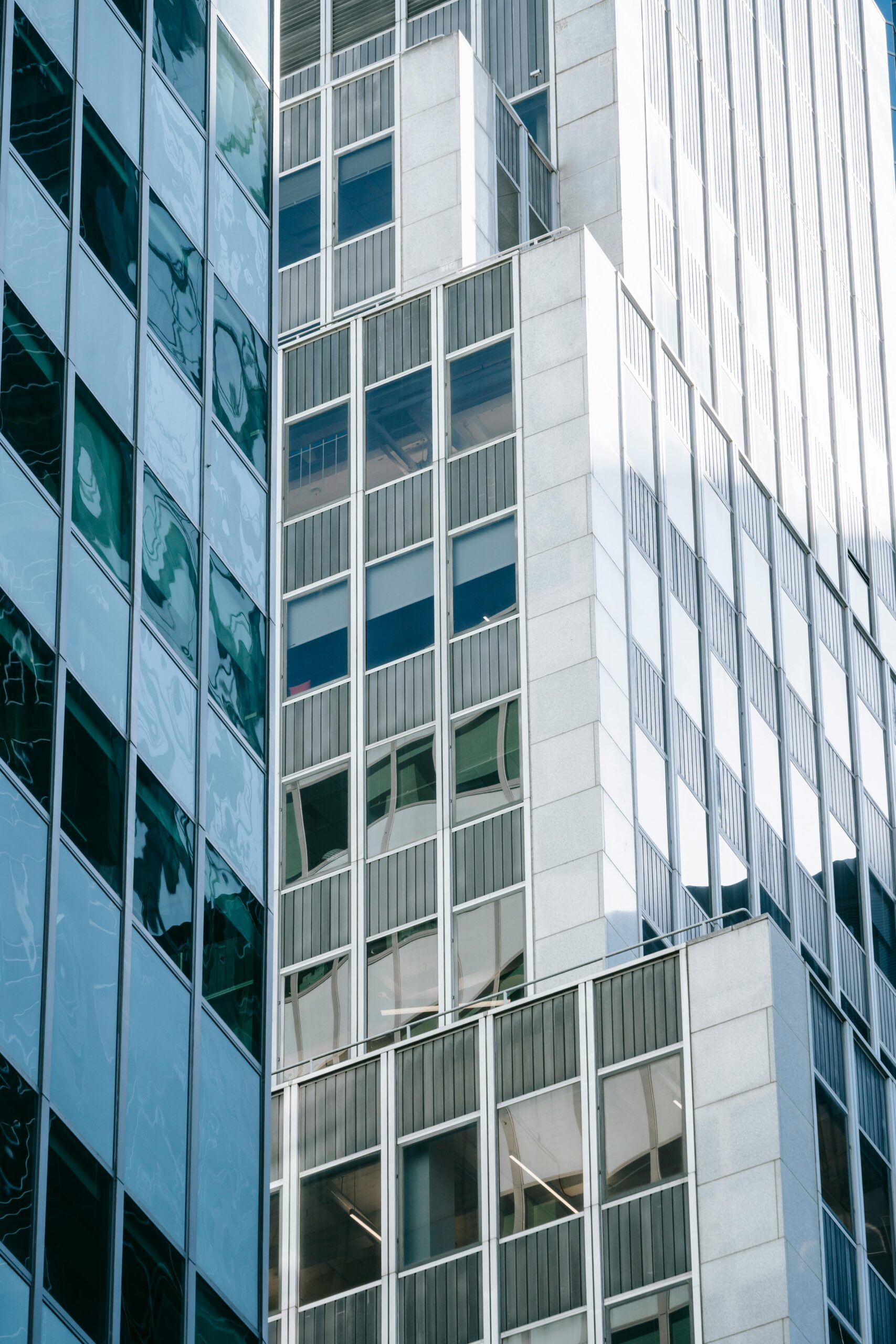 About Close-up of a modern urban skyscraper with reflective glass surfaces and minimalistic design.